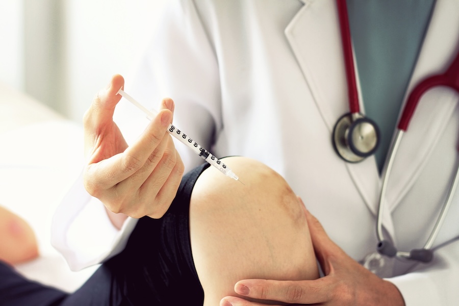 gp giving a cortisone injection in the knee