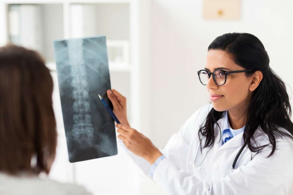 doctor explaining spine x-ray to patient