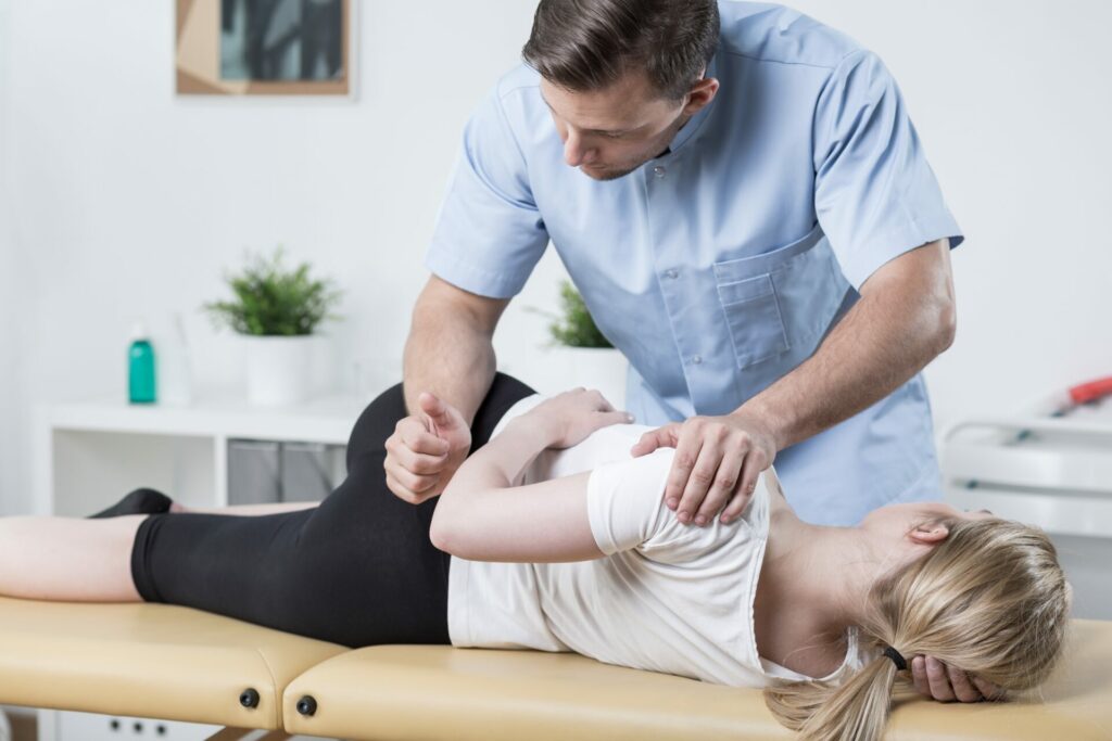 physiotherapist and patient on table