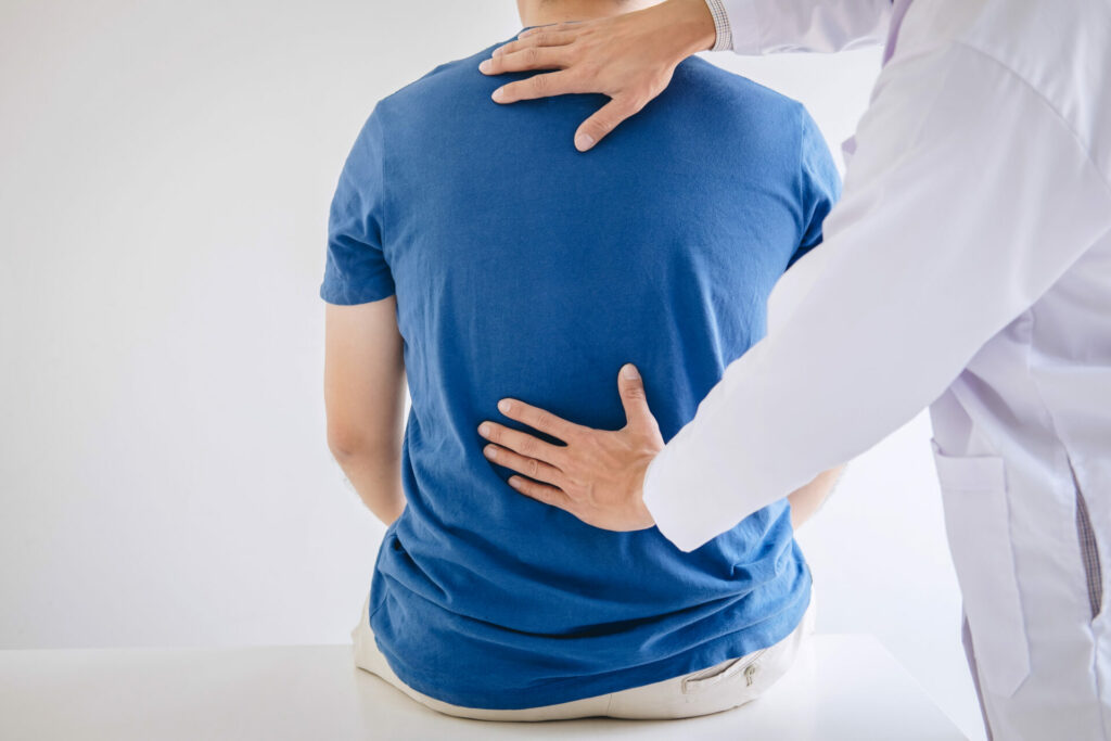 physiotherapist treating patient's lower back pain