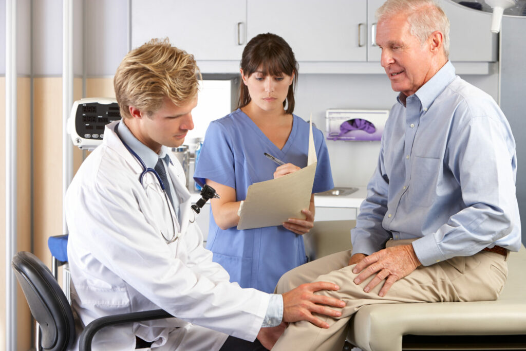 doctor examining patient with knee pain