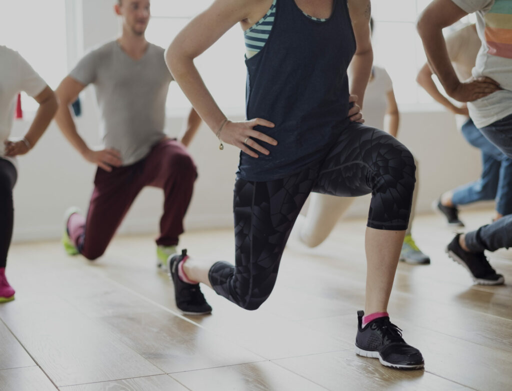 people lunging in a group exercise class